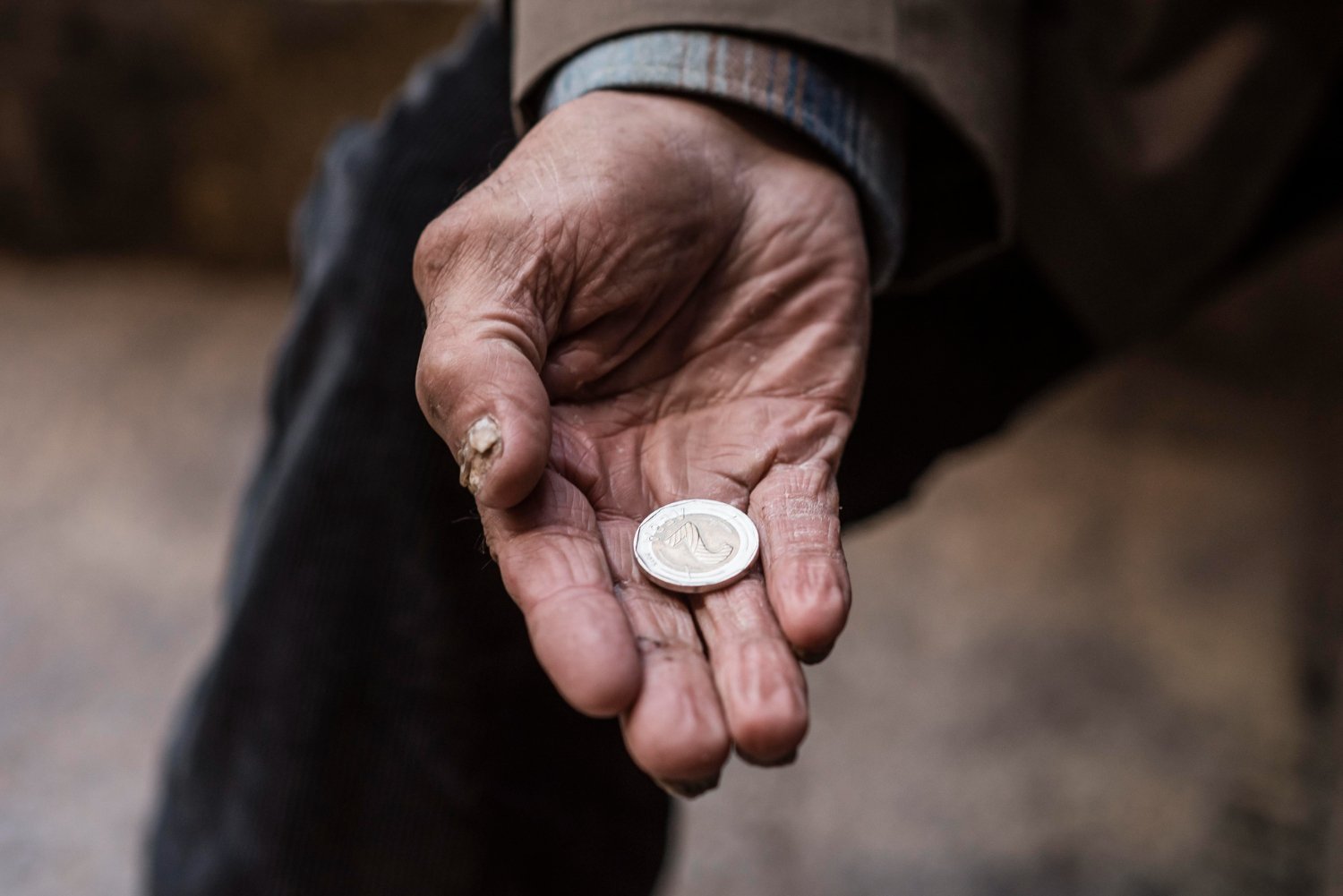 coin in the palm of a old person