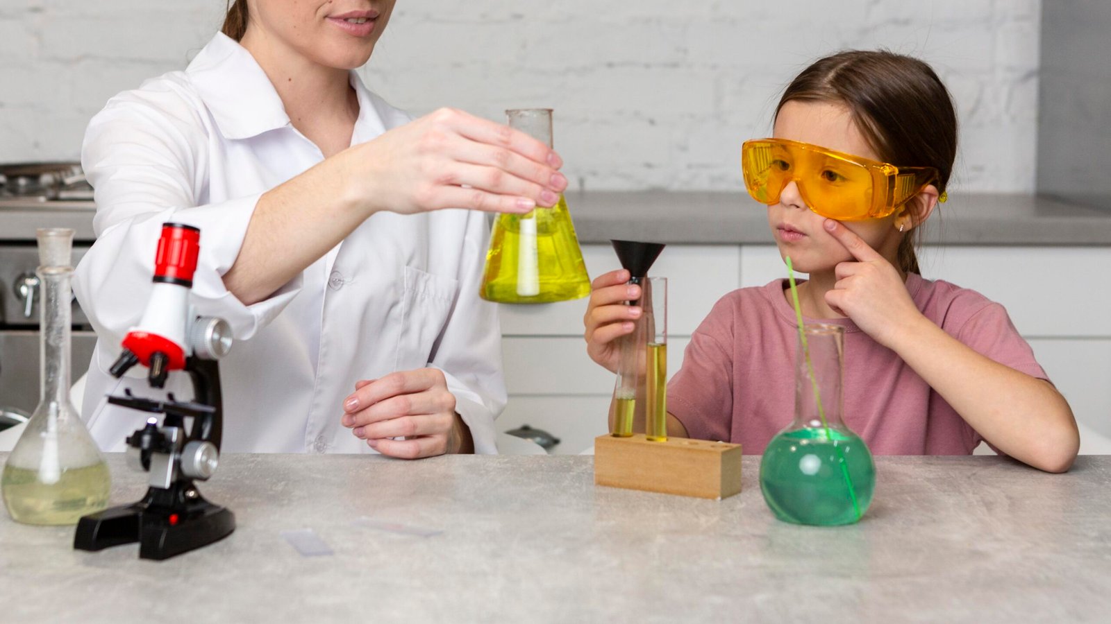 female-teacher-girl-doing-science-experiments-with-test-tubes-microscope