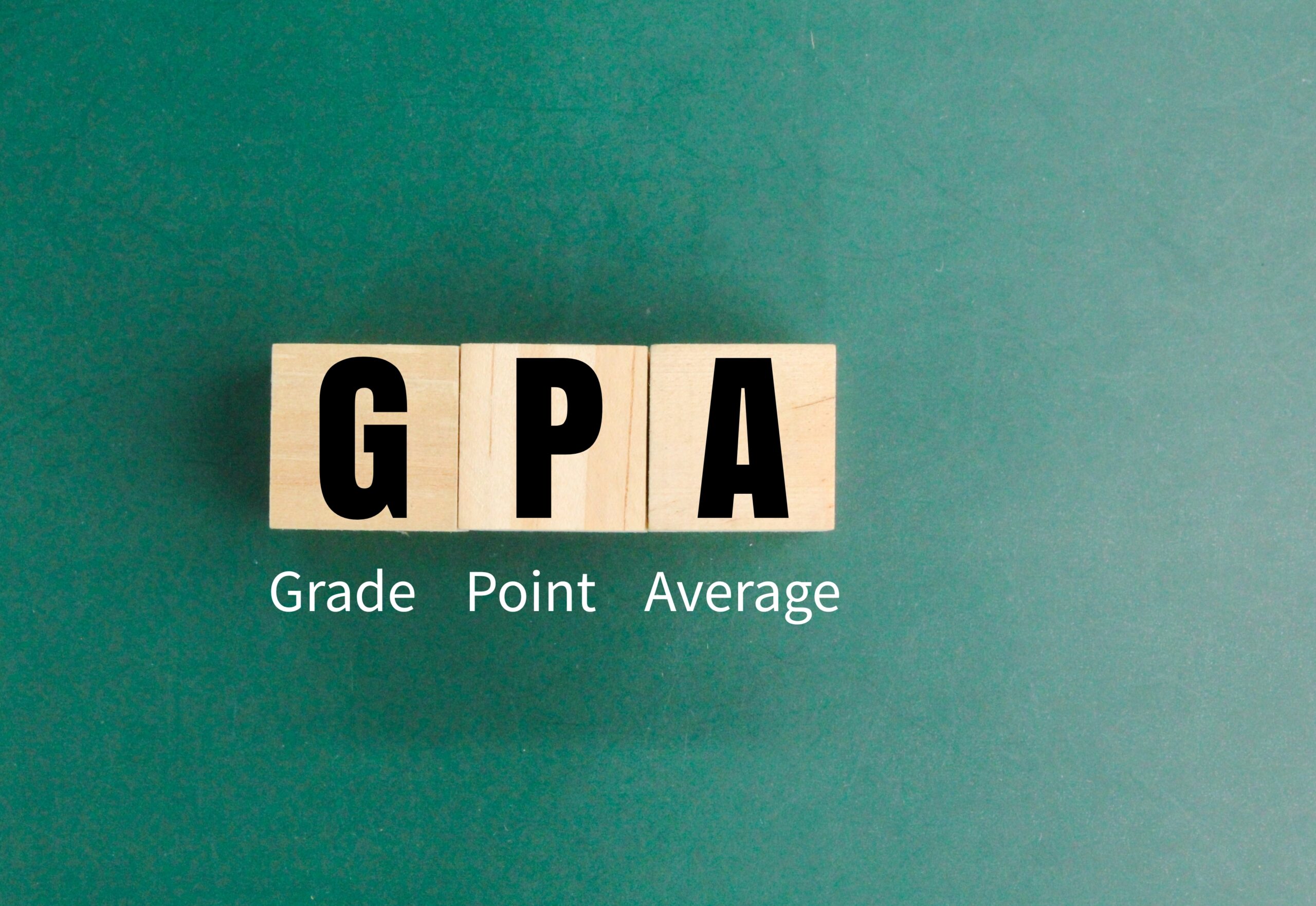 Wooden square with the letters GPA or the word grade point average